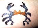 Black and orange colored fun body accessory art in crab shape supplied by teen temporary tattoo supply exchange company